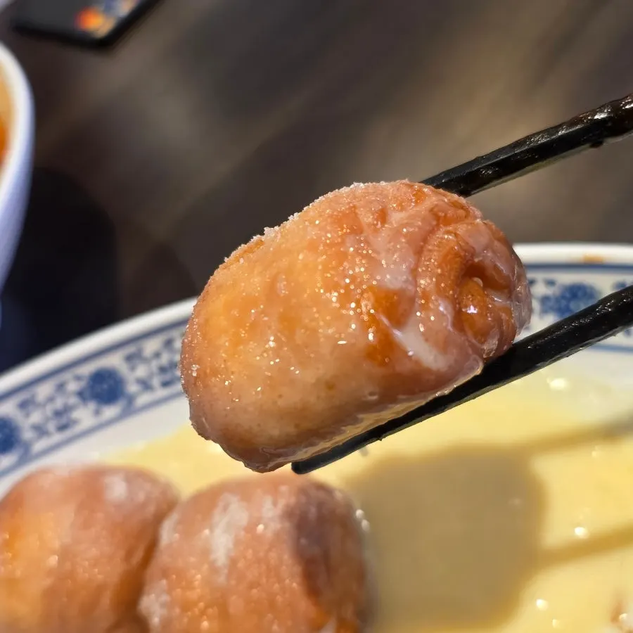 Dipping yeonyu kkotppang into condensed milk