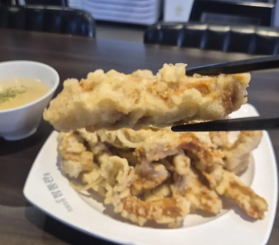 A piece of tangsuyuk dipped in sauce