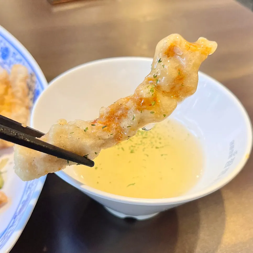 A piece of tangsuyuk dipped in sauce