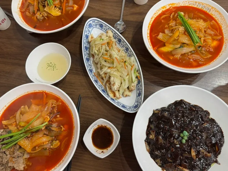 Table set with chadol jjamppong, jjajangmyeon, and mini tangsuyuk