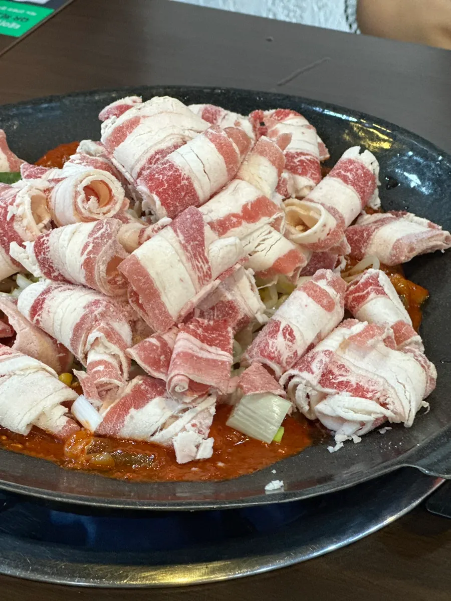 Pan of octopus for three topped with beef brisket