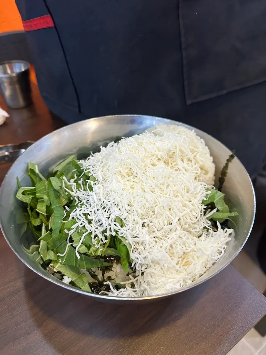 Cheese fried rice being stir-fried on the pan