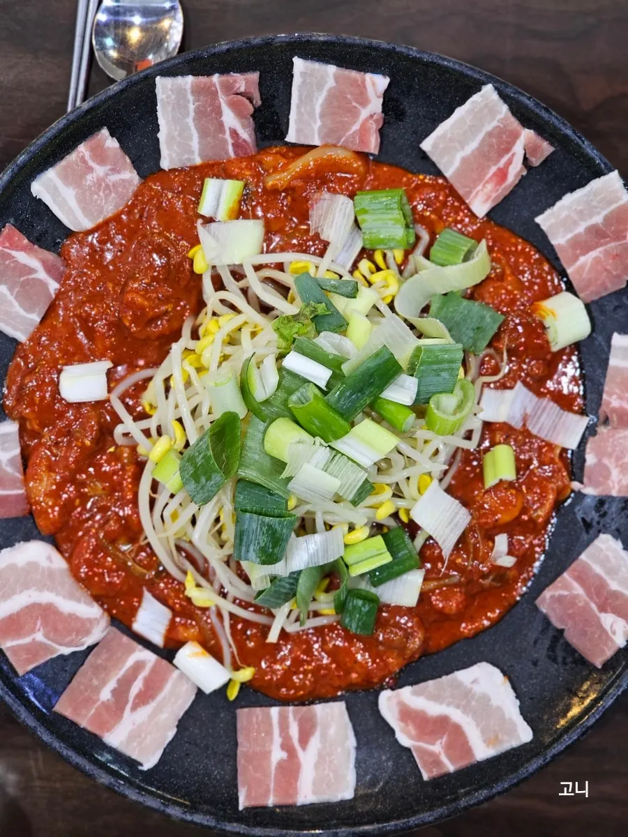 Octopus tossed in the 48-hour aged sauce on the hot plate