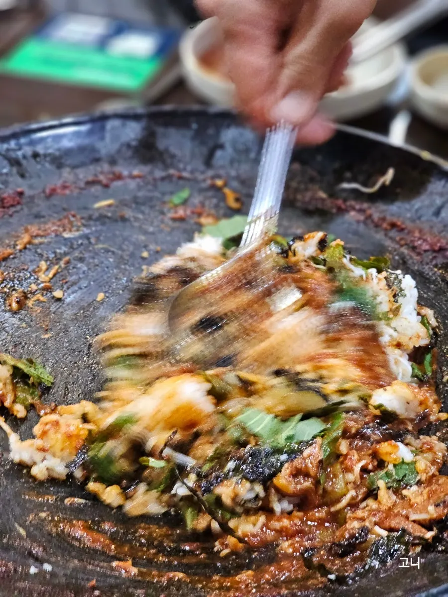 Fried rice topped with cheese on the hot plate