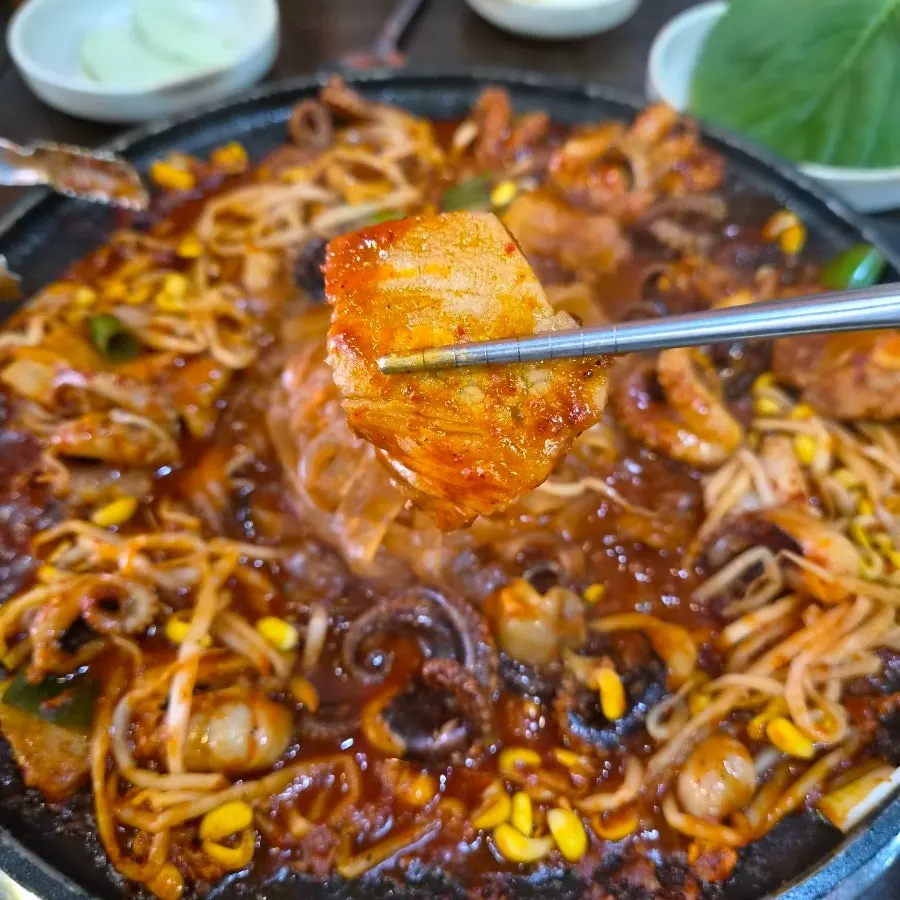 Octopus pork belly being stir-fried on the griddle