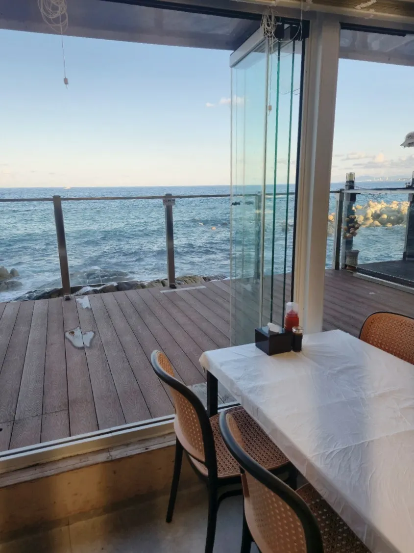 Ocean-view terrace seating at Jjin Susan