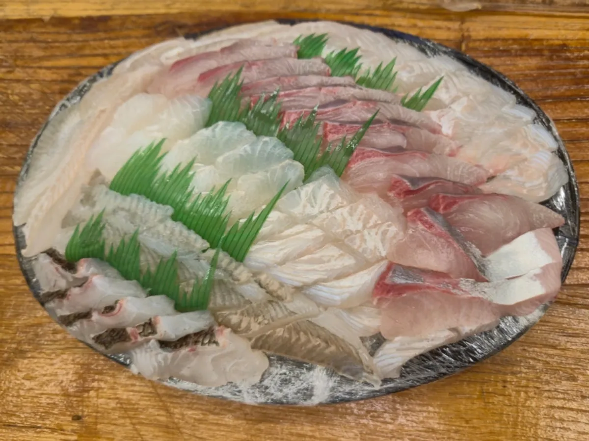 Close-up of assorted sashimi with visible grain texture