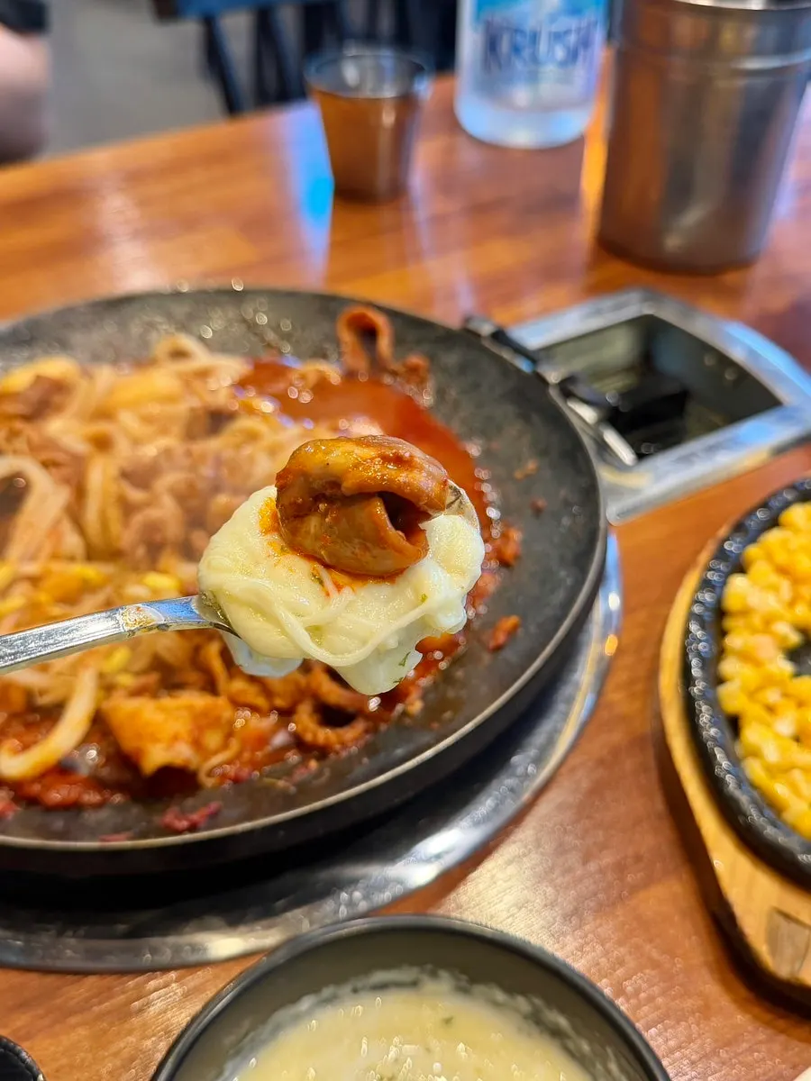 Webfoot octopus dipped in cheese fondue