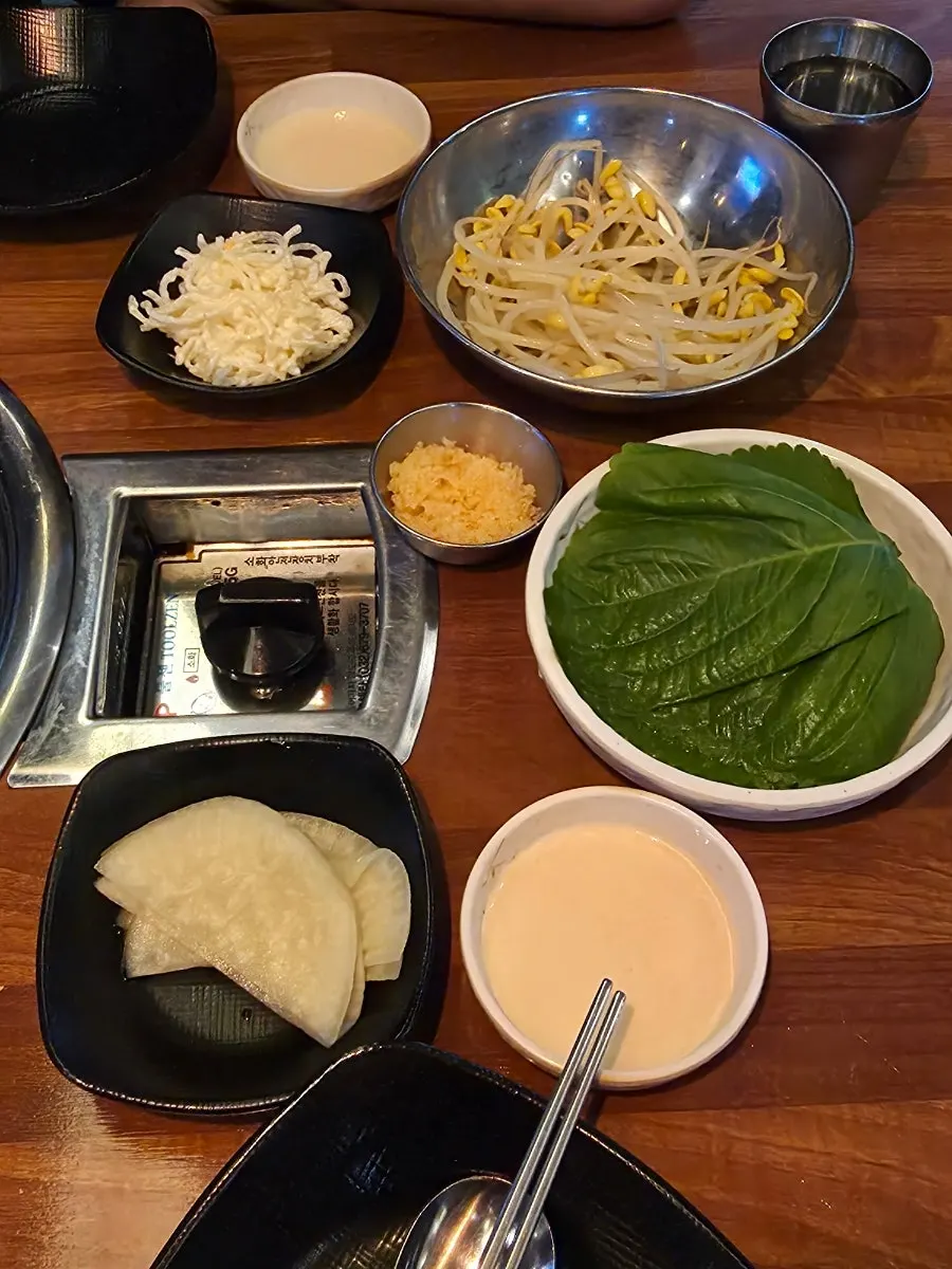 Basic table setup with perilla leaves, pickled radish, and cellophane noodle salad