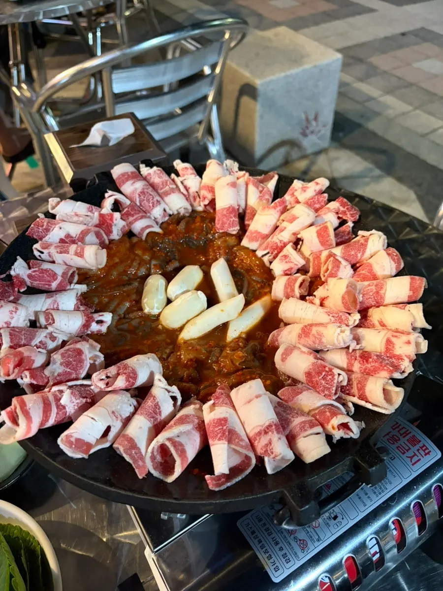 Jjuusam served at a patio table with a forest view