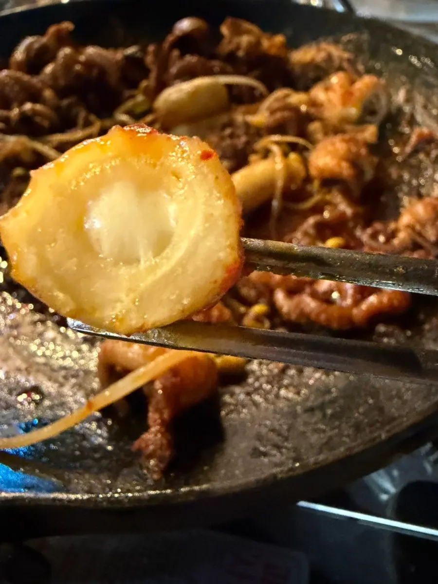 Tender beef brisket picked up with chopsticks