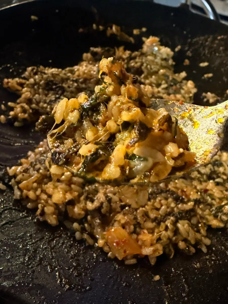 Finishing bokkeumbap fried with extra cheese and perilla leaves