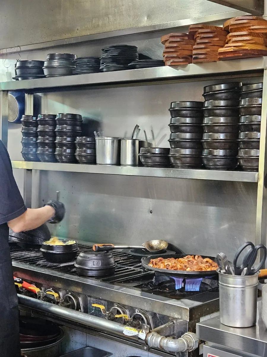 Octopus and pork belly dish being prepared in the kitchen