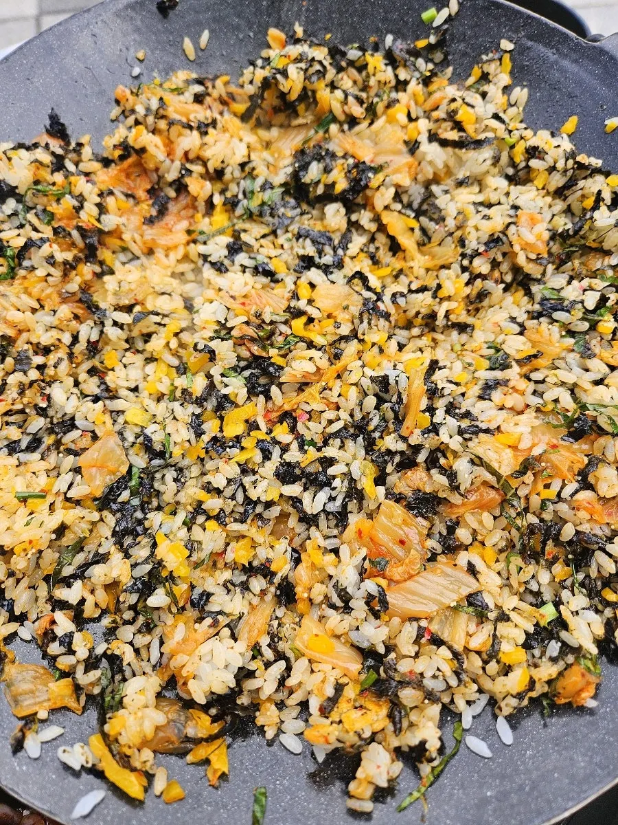 Frying rice on the griddle at the outdoor table