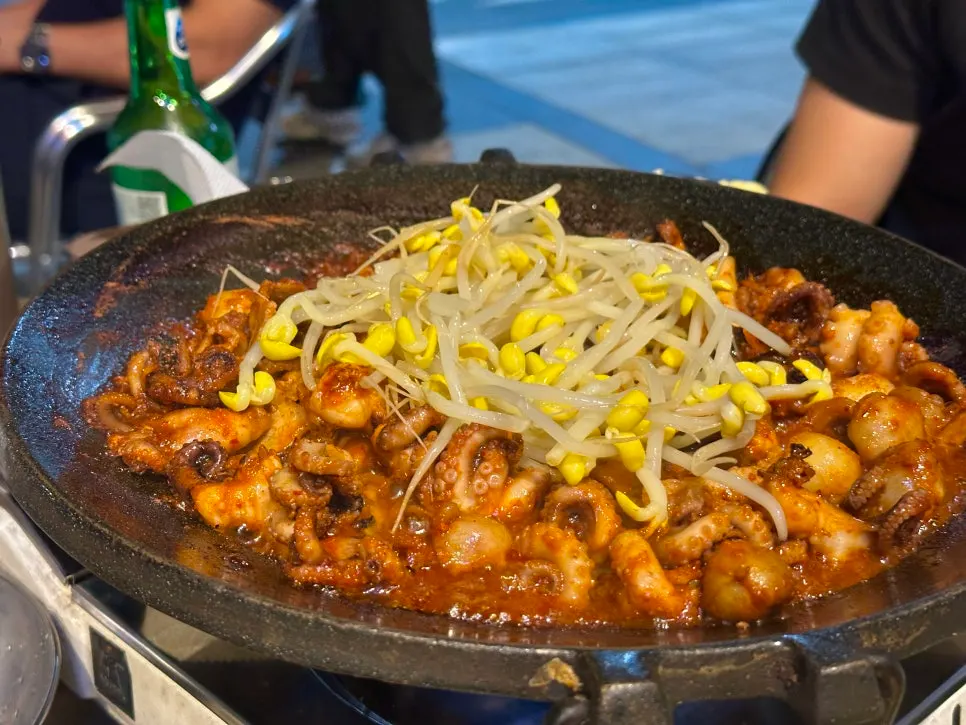 Octopus and pork belly cooking on the hot plate