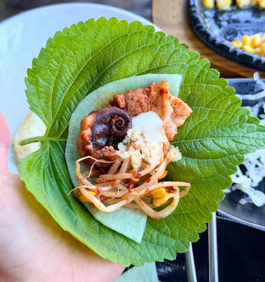 Ssam wrap of perilla leaf with pickled radish and octopus