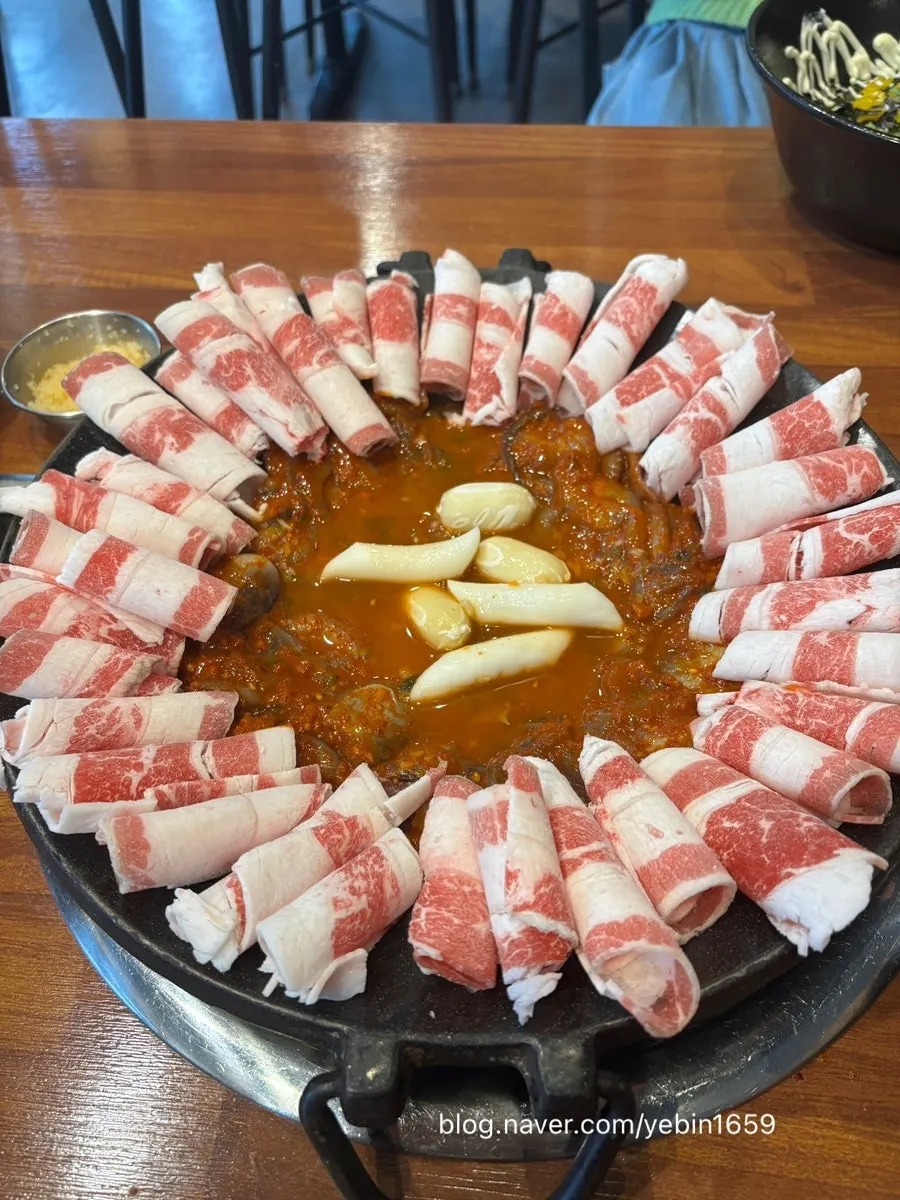 Jjuwoosam hot plate with beef brisket lined around the edge