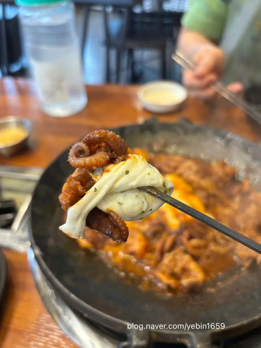 Octopus dipped in the added cheese fondue