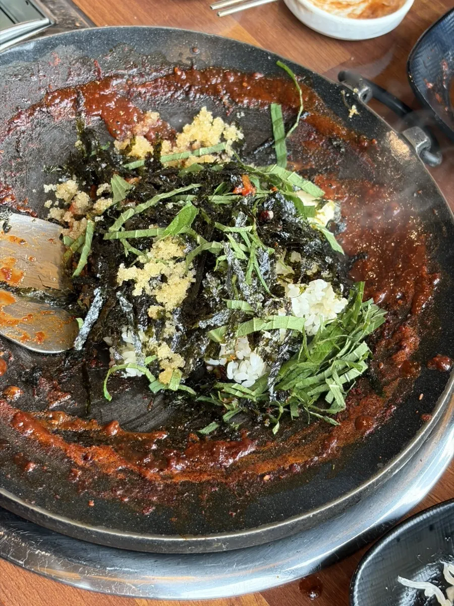 Flying fish roe cheese fried rice being cooked on the hot plate