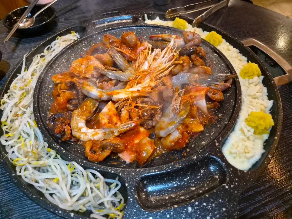 Staff member cooking the octopus hot plate