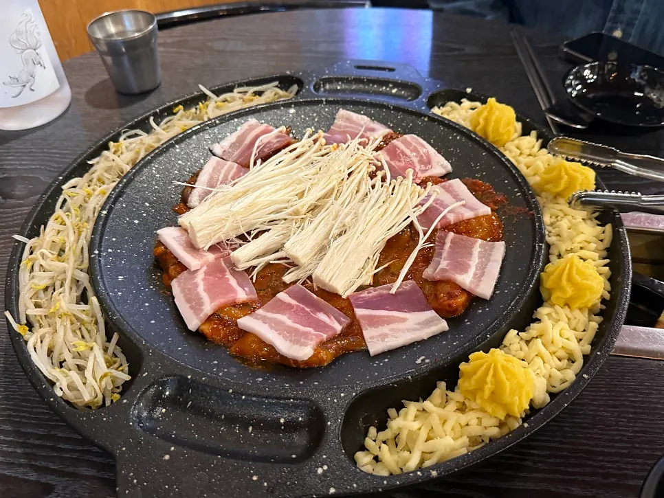 Octopus, pork belly, and enoki mushrooms on the hot plate