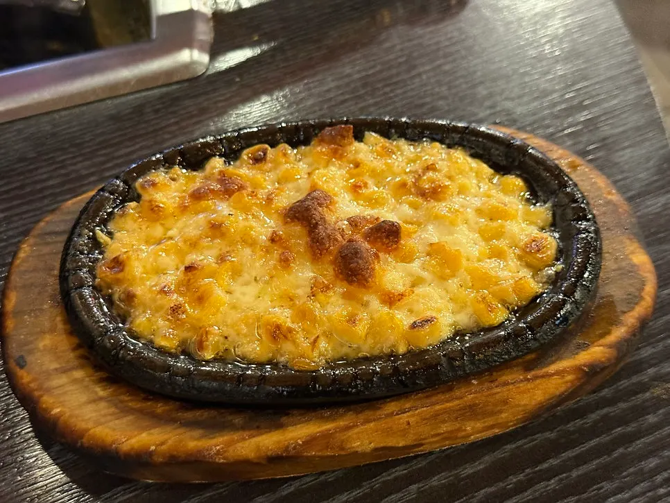 Cooked octopus and pork belly with stretched melted cheese