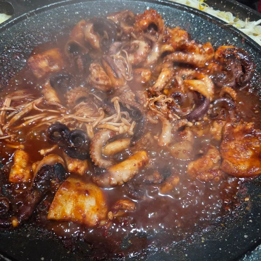 Octopus and pork belly bubbling on the pan