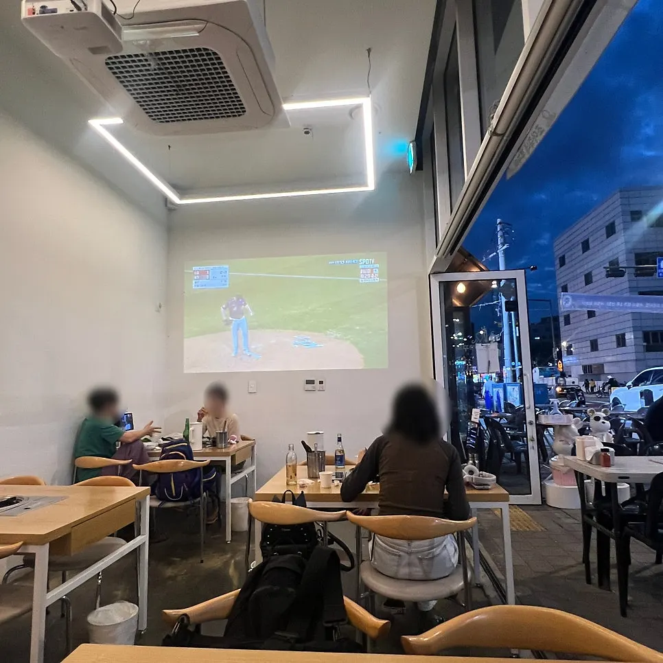 Indoor seats with a baseball game playing via projector