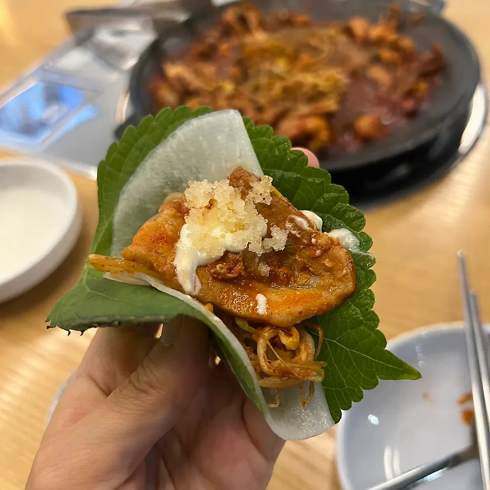 A perilla leaf wrap topped with pickled radish and roe
