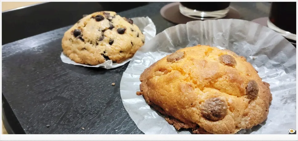 Chocolate chip cookie served with Americano
