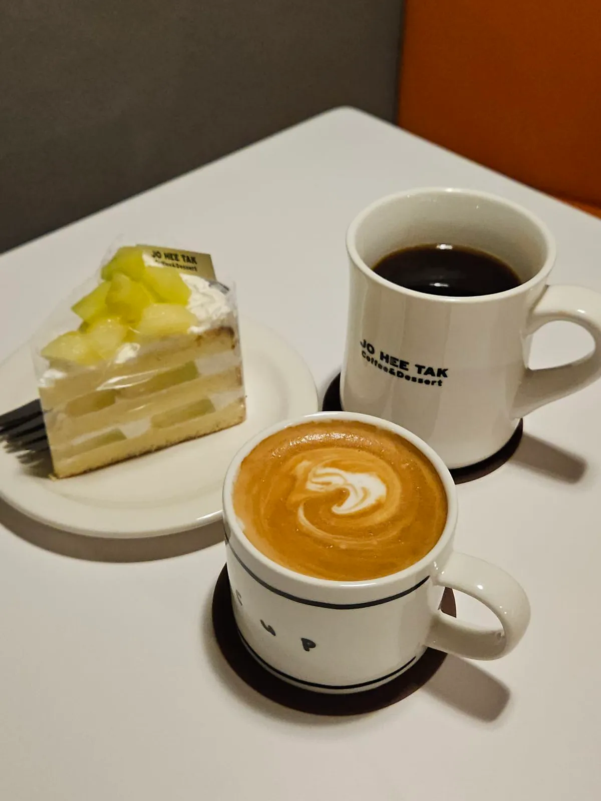 Flat white and musk melon cake at Jo Hui-tak Coffee