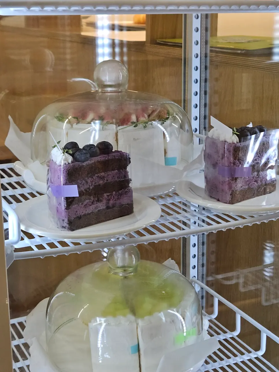 Fruit cream cakes and cheesecakes in the showcase