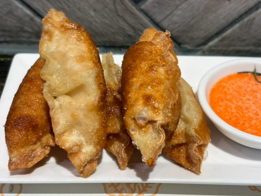 Plate of mentaiko gyoza served with mentaiko mayo sauce