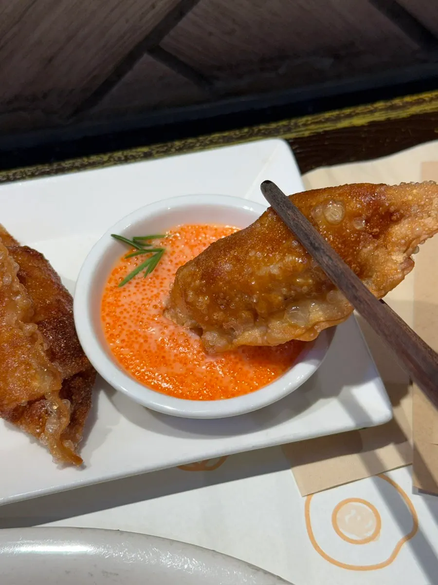 Mentaiko gyoza dipped in tobiko mayo sauce