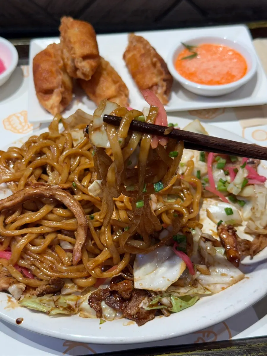 Springy yakisoba noodles lifted with chopsticks