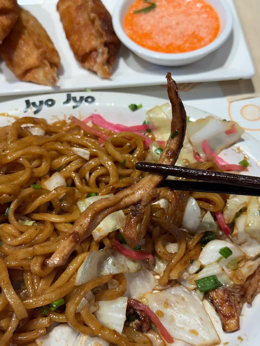 Red pickled ginger garnish on top of the yakisoba