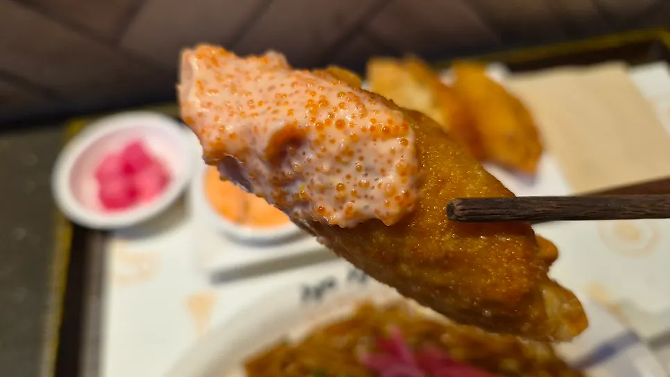 Gyoza dipped in mentaiko sauce