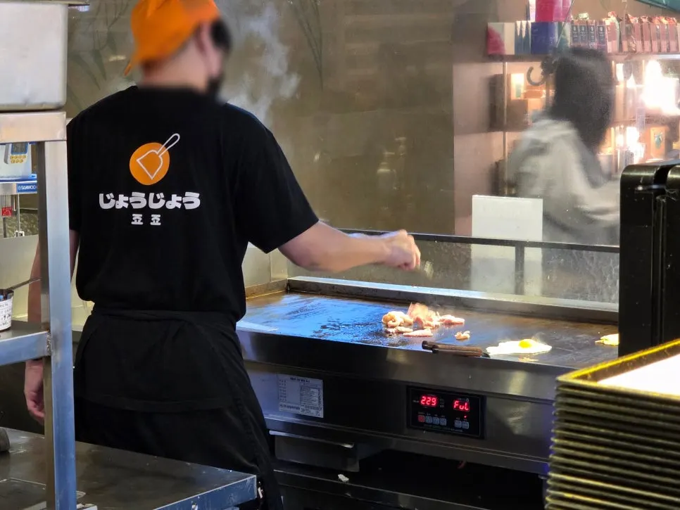 Jojo's open kitchen with ingredients cooking on the griddle