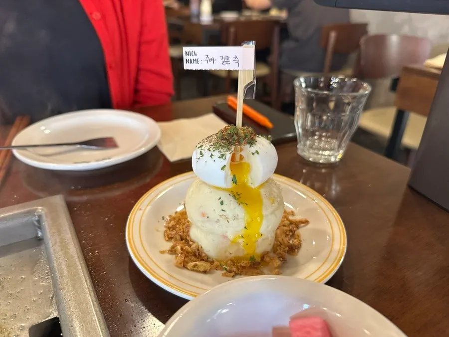 Waterfall potato topped with soft-boiled egg and onion chips