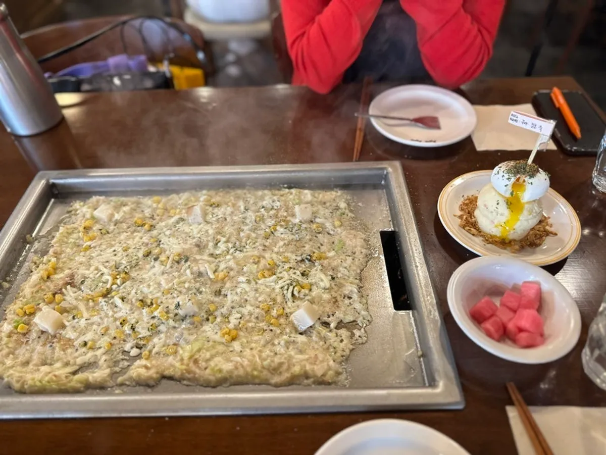 Mentaiko monjayaki spread thin to cook