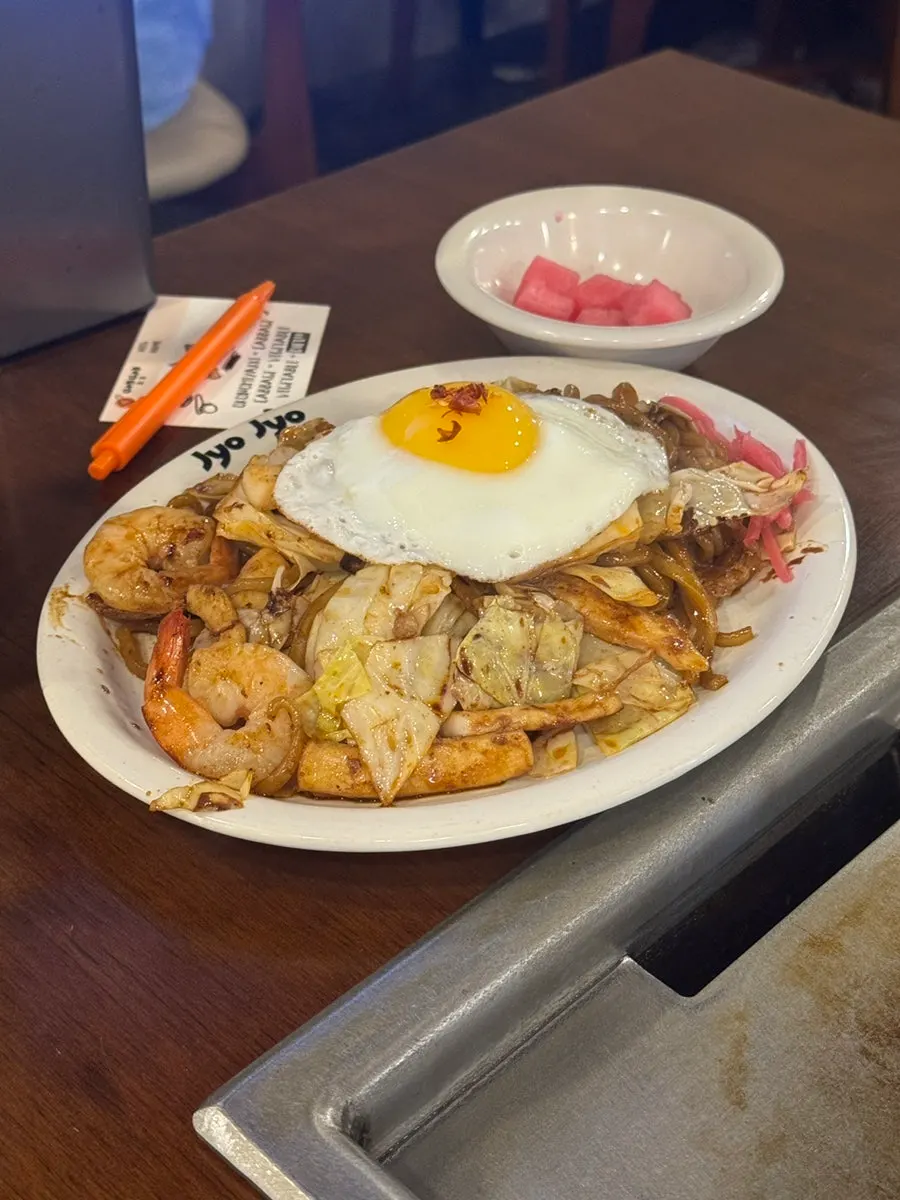 A bite of monjayaki scooped up with the scraper