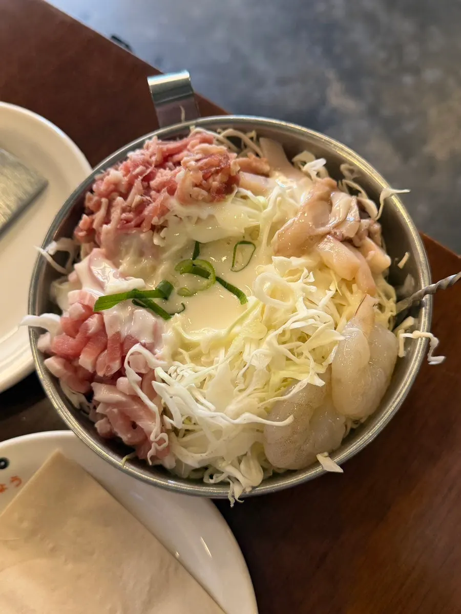 Okonomiyaki batter placed on the hot plate