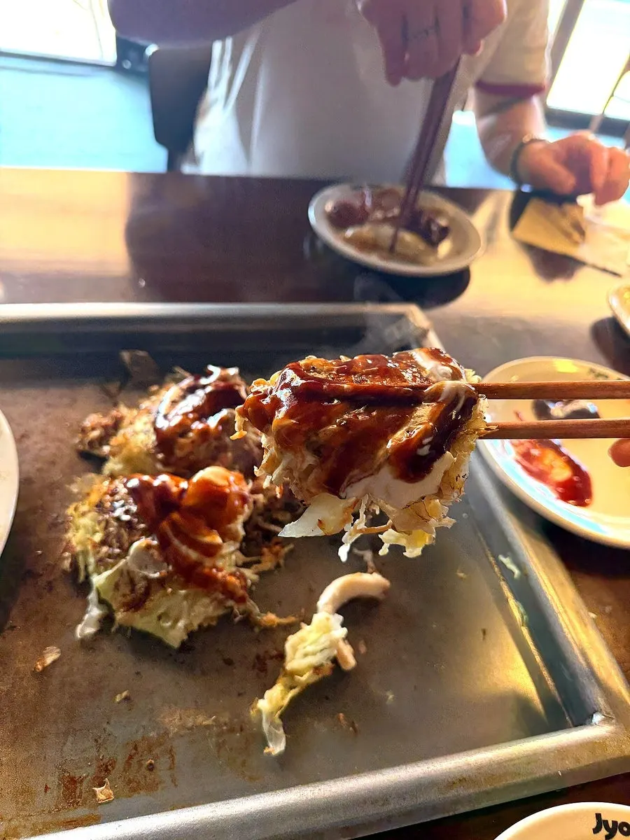Finished okonomiyaki topped with sauce