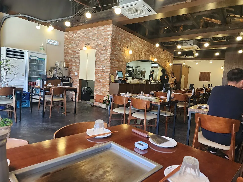Jojo Mullae Branch dining hall with rafter ceiling and soft lighting