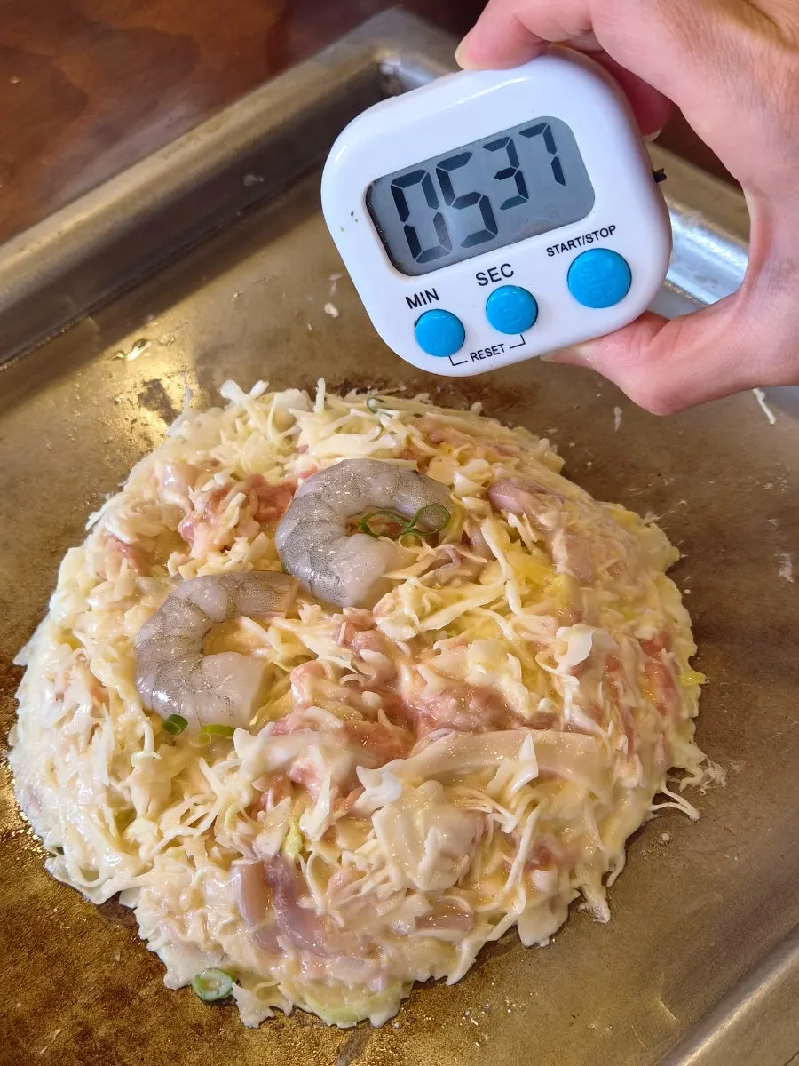 Okonomiyaki batter grilling on the teppan