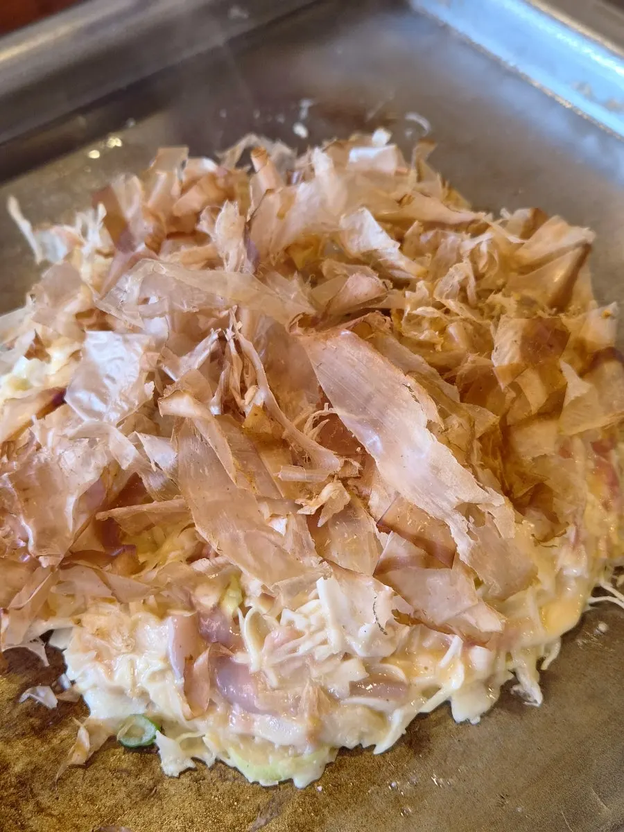 Close-up of okonomiyaki brushed with house sauce