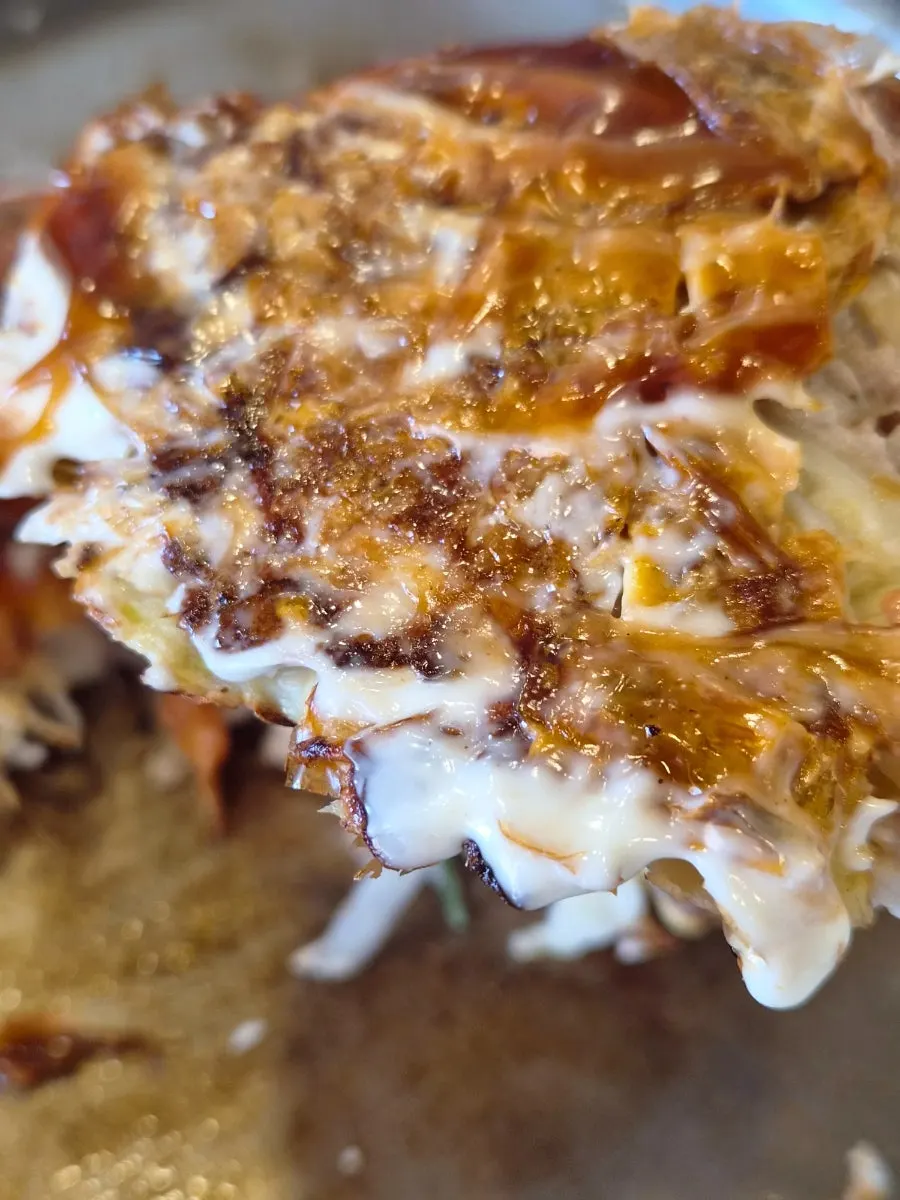A slice of okonomiyaki on a plate