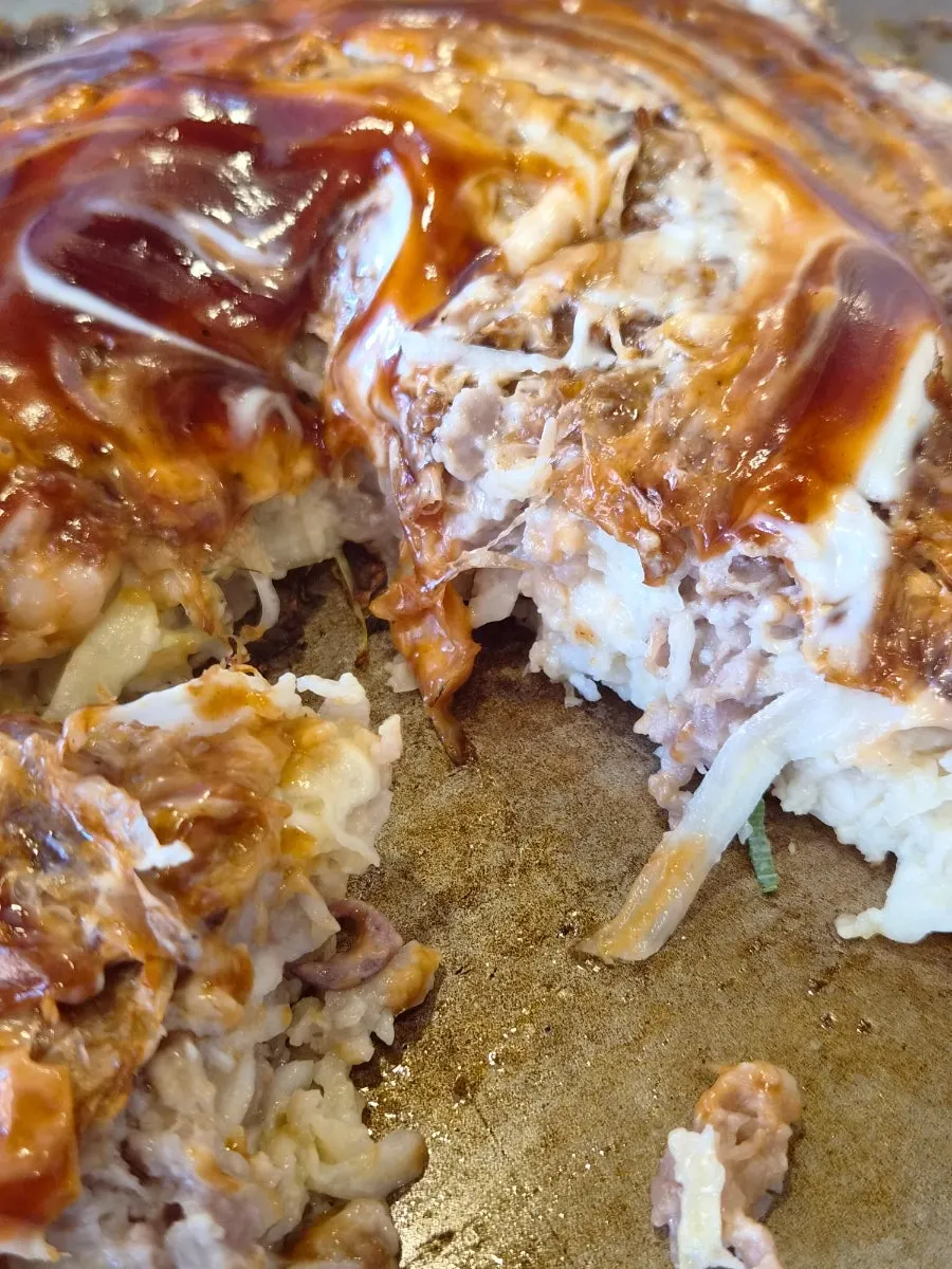 Okonomiyaki and bonito flakes on the teppan