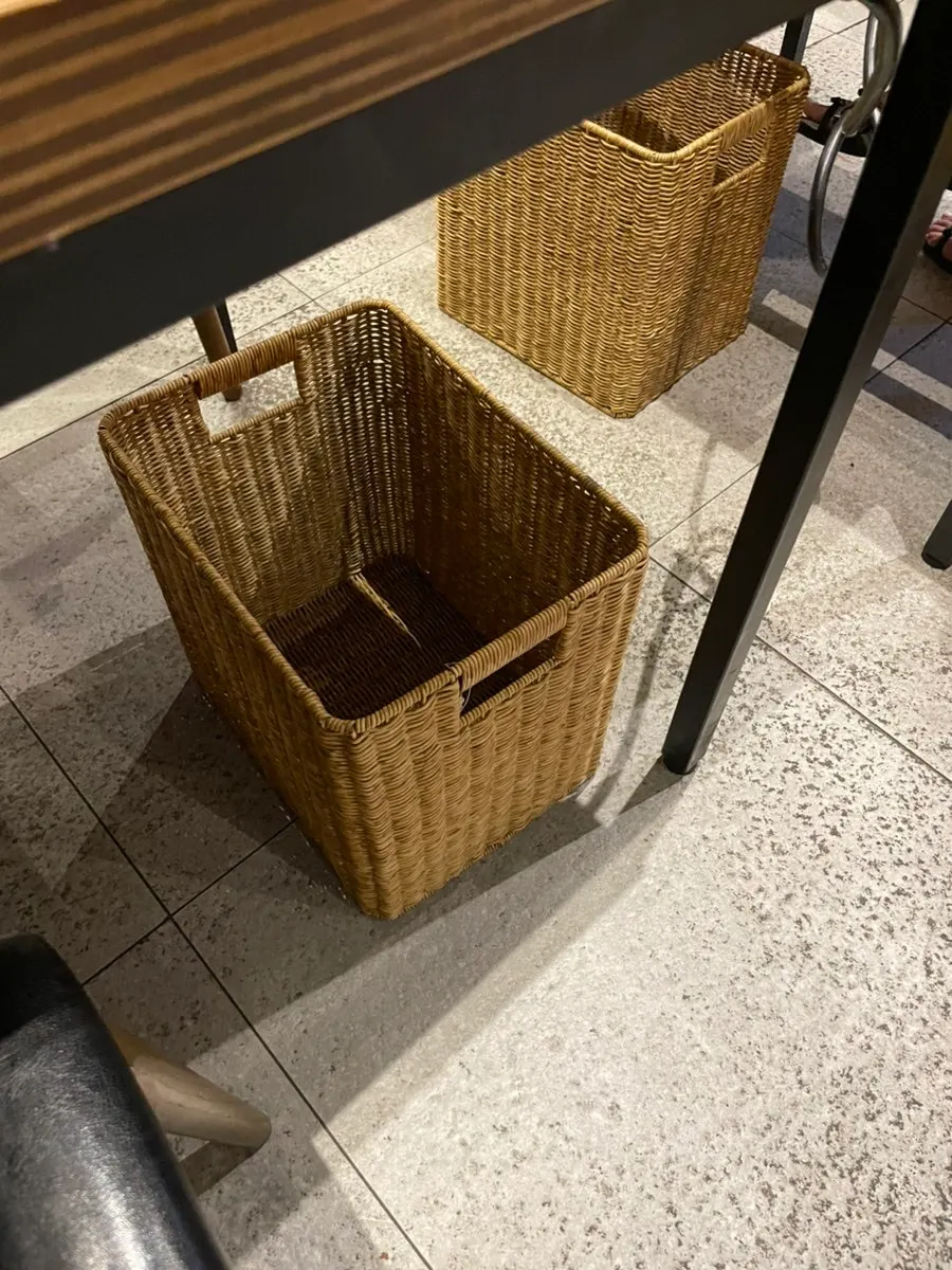 Baskets under the table for storing belongings