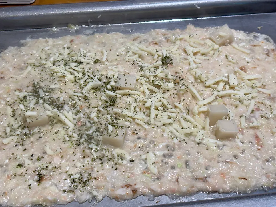 Finished monjayaki topped with mochi and cheese